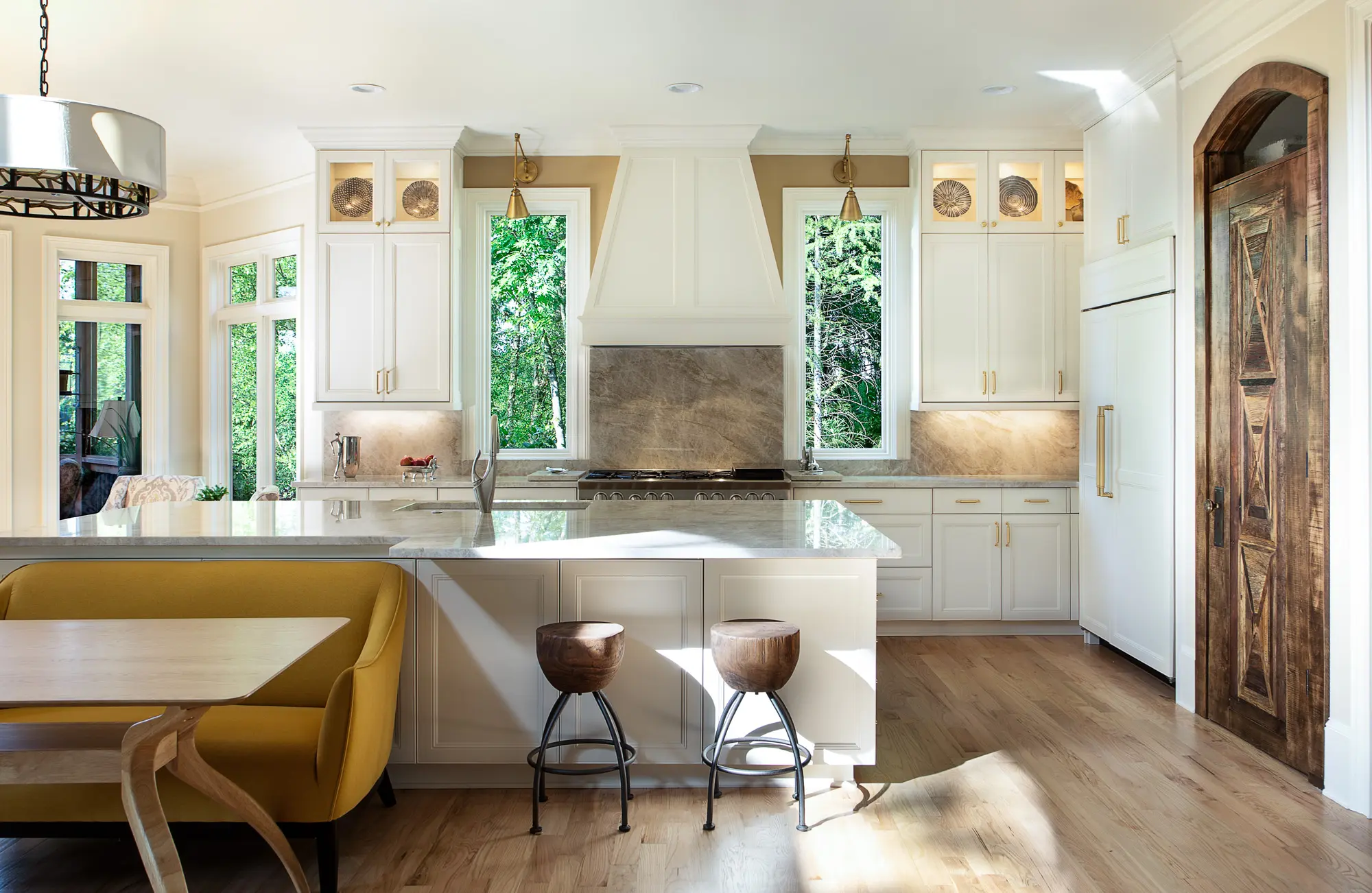 Bright contemporary kitchen remodel with white cabinetry and marble countertops by Michael James Remodeling. Bright contemporary kitchen remodel with white cabinetry and marble countertops by Michael James Remodeling.