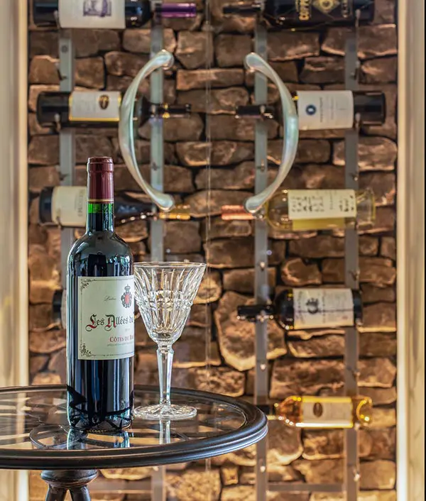 Custom wine storage with stone backdrop and elegant display table by Michael James Remodeling. Custom wine storage with stone backdrop and elegant display table by Michael James Remodeling.